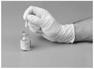 Insert the exposed short part of the needle through the diluent stopper.