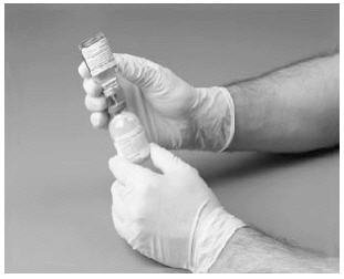 Insert the free end of the needle through the concentrate vial stopper at its center. The vacuum in the vial will draw in the diluent. Invert the diluent vial over the upright concentrate vial.